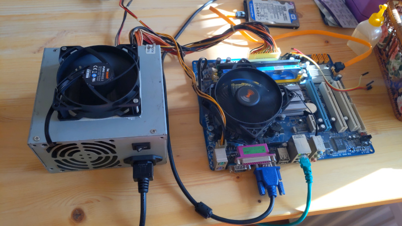 a PSU with motherboard working on a table naked